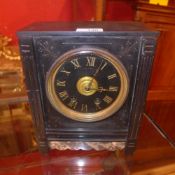 A rectangular form mantel clock the dial with gilded Roman numerals