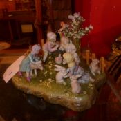 A Continental porcelain figure group of four cherubs heightened in gilt