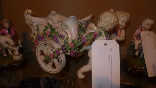 A Continental porcelain figure group of cherubs and carriage