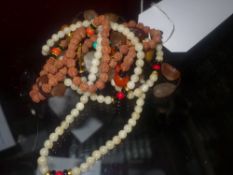 A desert agate necklace and a white stone beaded necklace