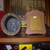 A carved Indian photograph frame with Arabesque design together with an oval mirror with rose