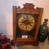 An American mantle clock with circular painted brass Roman numeral dial