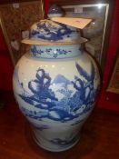 A large Chinese blue and white lidded vase decorated with landscape reserves