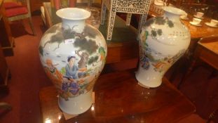 A pair of chinese vases of large size decorated with social scene pictorial reserves