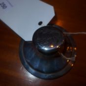 A hallmarked silver inkwell with engraved lion detail on the lid