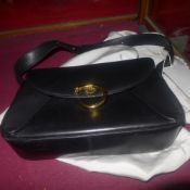 A black leather Cartier ladies handbag