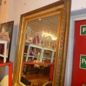 A wall mirror of large size the rectangular plate on heavy giltwood frame