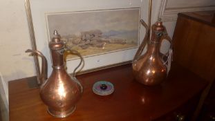 A pair of C19th copper and brass ewers