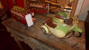 A painted tin model of an open top bus and a similar of a scooter and side car