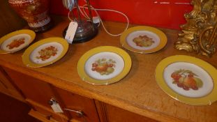A set of four Portuguese plates decorated with fruit