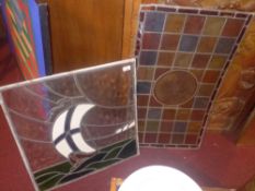 Two stained leaded glass panels one with hand painted landscape reserve and the other with image