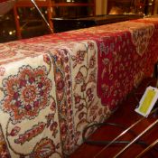 A Kum design carpet with an ivory medallion on a red field with ivory spandrels surrounded by one