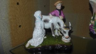 A pair of porcelain figure groups of farmers and their animals