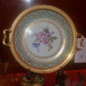 A Chapus Freres Limoges twin handled gilt metal bound plate decorated with flowers and associated