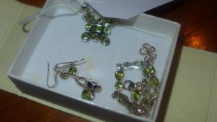 A suite of sterling silver and peridot jewellery consisting of a pendant bracelet and earrings