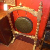 A large dinner gong in carved frame