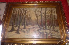 An oil on board winter landscape in the woods in a heavy giltwood frame