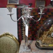 A pair of Corinthian column form silver plated candelabra of five twisted branches on pedestal base