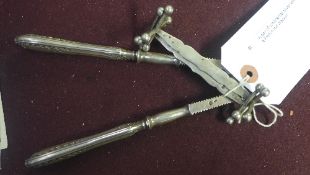 A pair of continental silver knife rests together with a French nut cracker