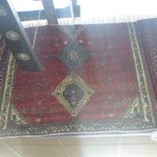 An extremely fine South West Persian Abadeh carpet repeating pole medallion on a terracotta field