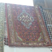 A fine North West Persian Malayer runner triple pole medallion with repeating motifs on a terracotta