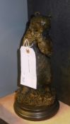 A bronzed bear on stand