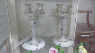 A pair of twin branch Herand candlesticks ornately gilt decorated with birds and insects