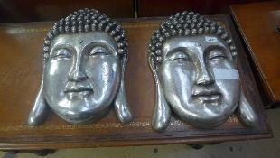 A pair of silvered Buddha wall plaques