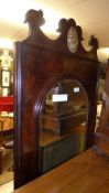 An antique walnut hall mirror the arched bevelled plate within carved crest