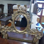 A French style gilded wall mirror with bevelled plate and carved frame