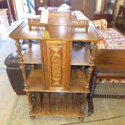 A C20th parquetry inlaid music cabinet with cupboard above divisions on castors