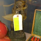 A bronzed bear on stand