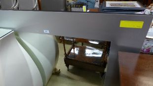 A contemporary wall mirror with steel square frame