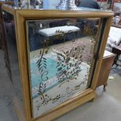 An Art Deco mirrored cocktail cabinet with swivel mirror door revealing demi-lune shelves on squat