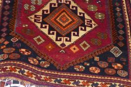 A fine old South West Persian Lori rug bearing triple pole medallion on a terracotta field guarded