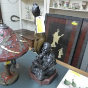 A bronzed figure of a nude female slave and seated Arab seller
