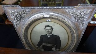 A Monochrome print portrait of a gentleman in husk carved frame