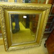 A Rococo style mirror the bevelled plate in carved frame