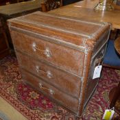 A faux leather luggage design three drawer chest