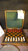 A leather travelling case with fitted chess set