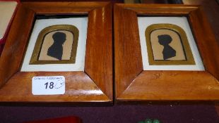 A pair of portrait silhouettes in maple