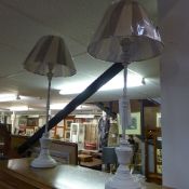 A pair of white painted slender continental style table lamps
