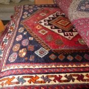 A fine old South West Persian Lori rug bearing triple pole medallion on a terracotta field guarded