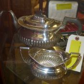 A hallmarked silver teapot and sucrier