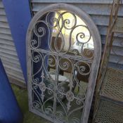 An arched gated front garden mirror