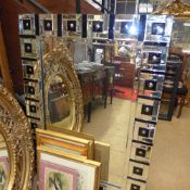 A contemporary wall mirror the rectangular plate with segmented border