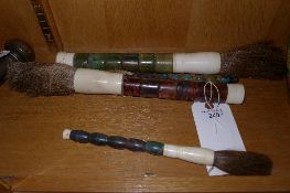 A set of four calligraphy paint brushes