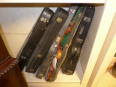 A set of four violins and cases