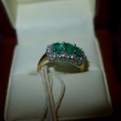 An 18ct gold ring with triple emerald in