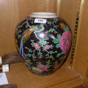 A Japanese famille rose ginger jar, with floral and Phoenix detailing on a black ground. height 24cm